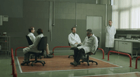 a group of people sitting in chairs in a room