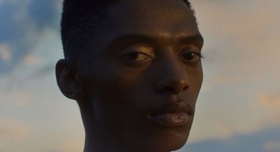 a close up of a person wearing a suit and tie