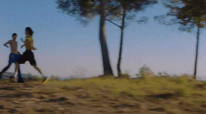 a man and a woman running through a field