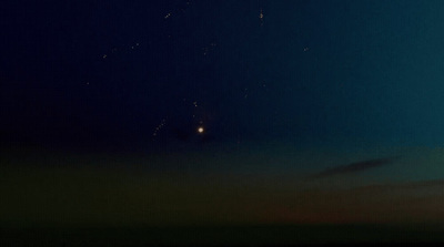 a group of people flying kites in the night sky