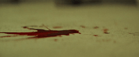 a blood stained piece of paper sitting on top of a table