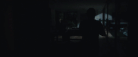 a person standing in a dark room in the dark