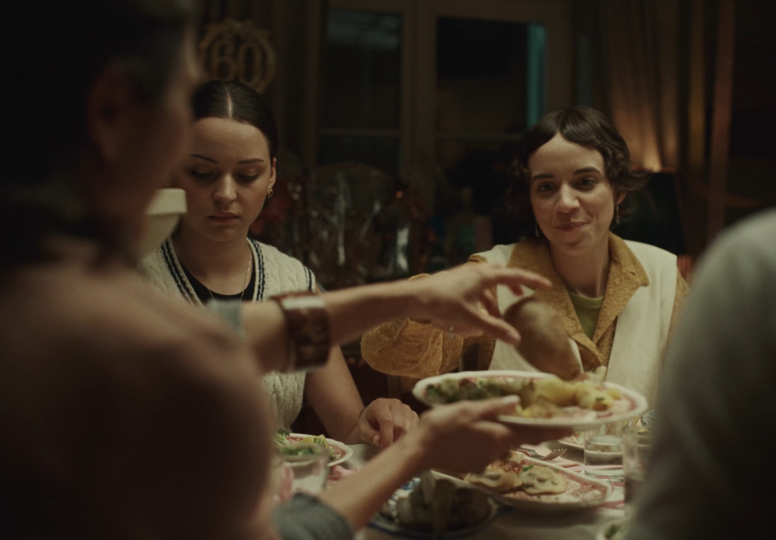 a group of people sitting around a table eating food