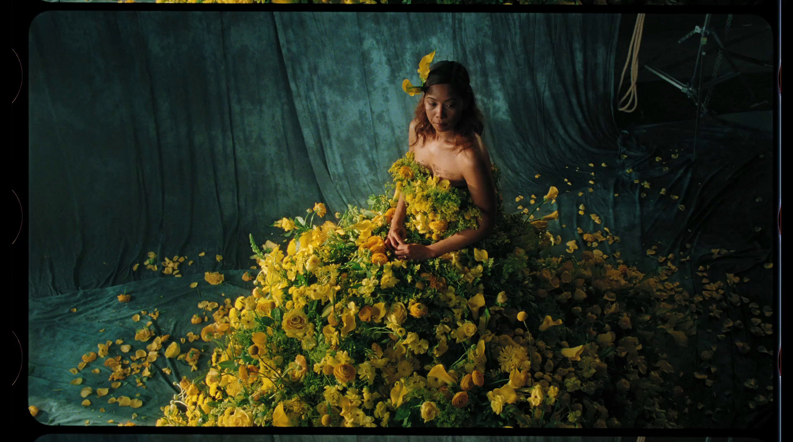 a woman in a dress made of flowers