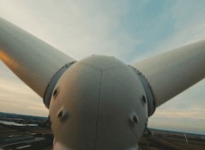 a close up of a wind turbine on a cloudy day