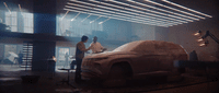 two men working on a car in a garage