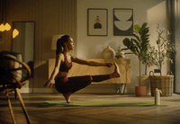 a woman in a yoga pose in a living room