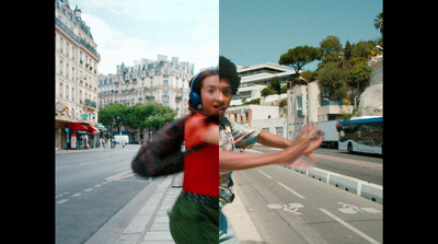 a man in a red shirt is running down the street