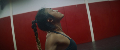 a woman with braids standing in a gym