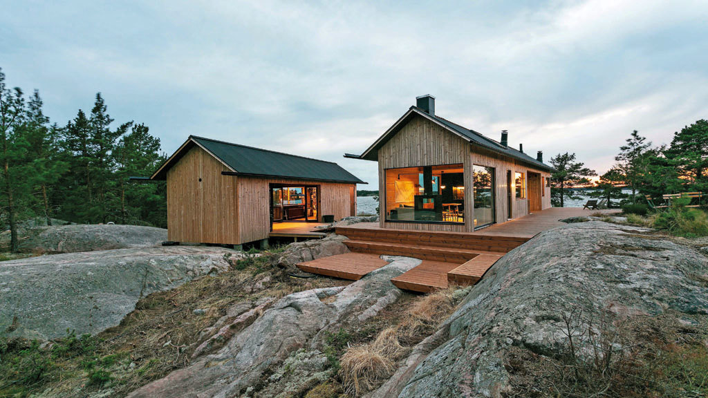 a couple of small houses sitting on top of a rocky hillside