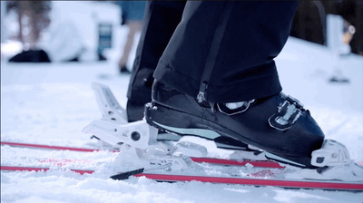 a person standing on a pair of skis in the snow