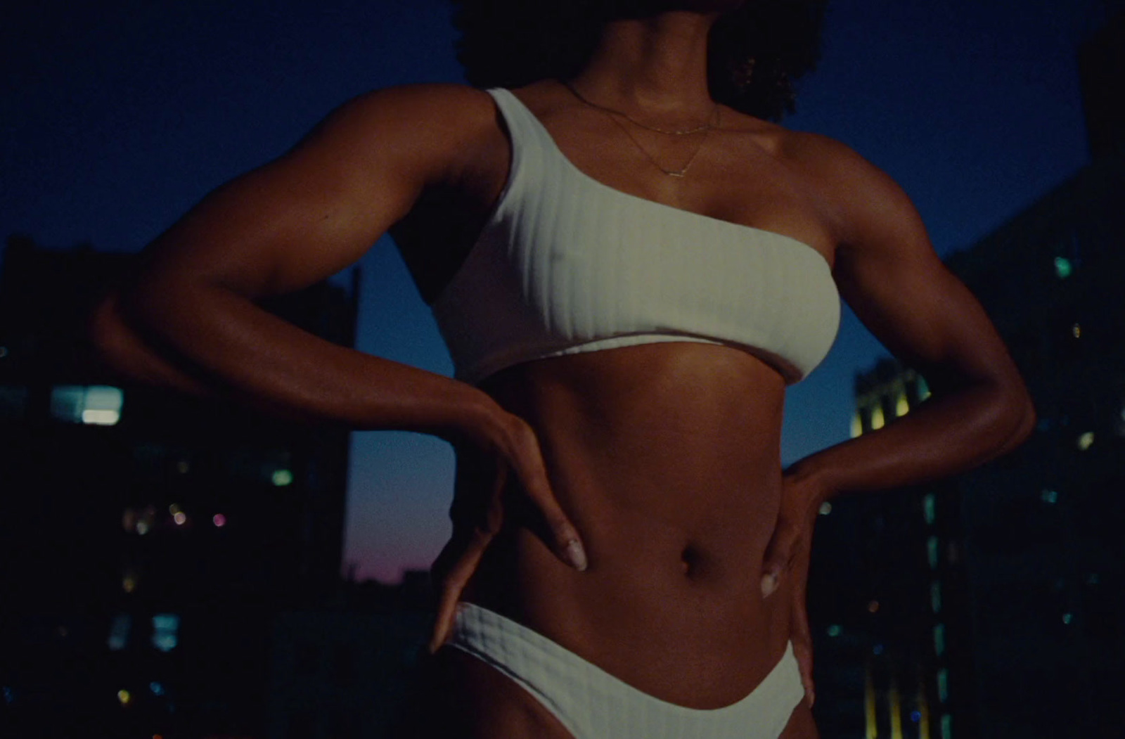 a woman in a white bikini posing for a picture