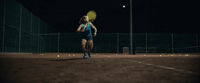 a woman is playing tennis on a tennis court