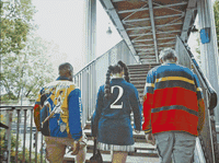 a group of people walking up a flight of stairs