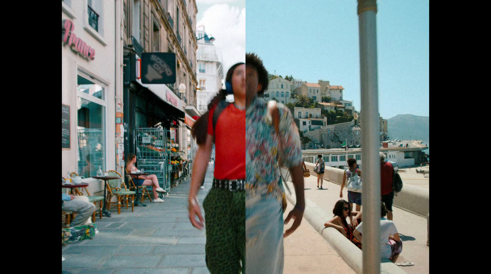 a man walking down a street next to a tall pole