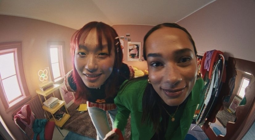 two women taking a selfie in a mirror