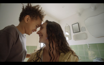 a man and a woman standing next to each other in a bathroom