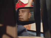 a man looking out the window of a car