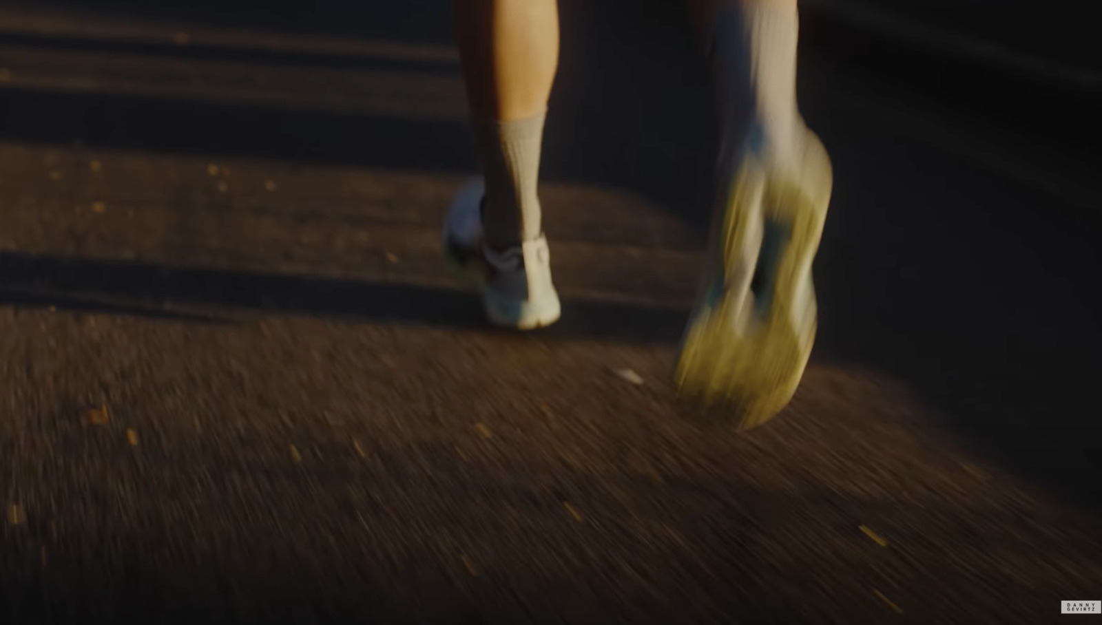 a person walking down a street with yellow shoes