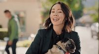 a woman holding a dog in her lap