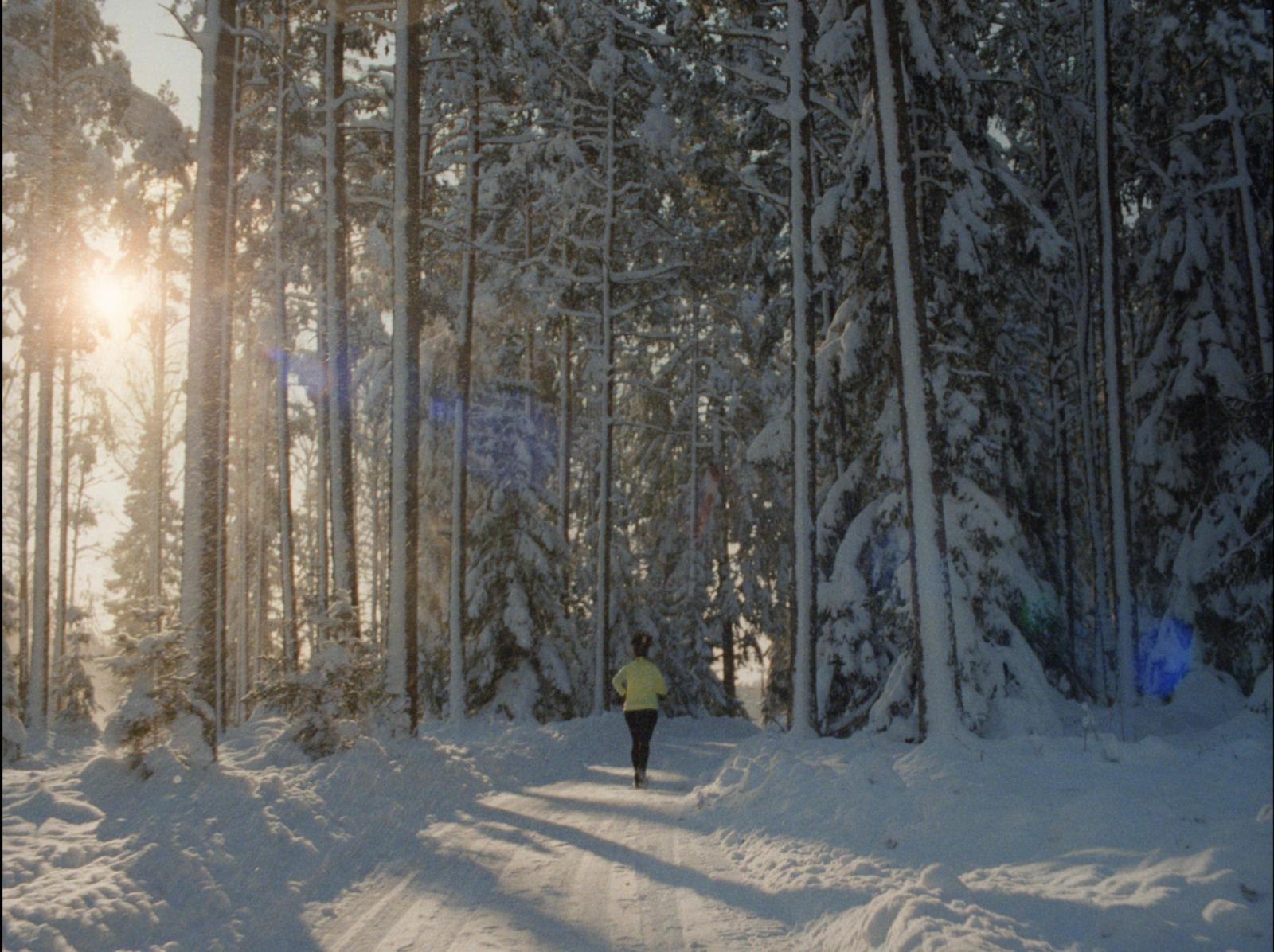 a person walking through a snow covered forest