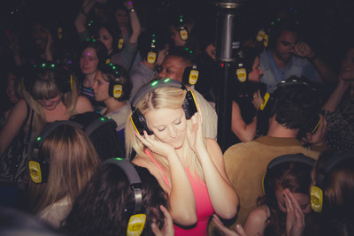 a woman wearing headphones in a crowd of people