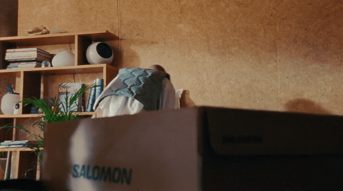 a living room filled with furniture and a wooden shelf
