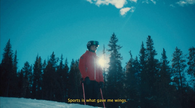 a man standing on top of a snow covered slope