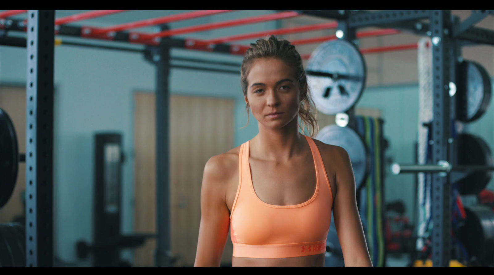 a woman in a sports bra top in a gym