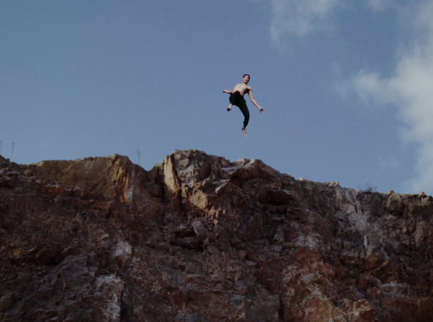 a man flying through the air while riding a skateboard