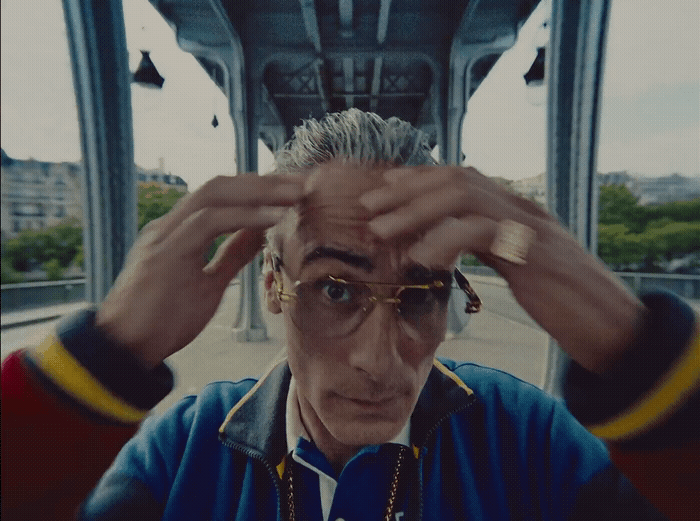 a man wearing glasses and a blue jacket