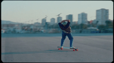 a man riding a skateboard in a parking lot