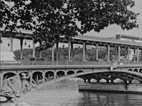 a black and white photo of a bridge over a river