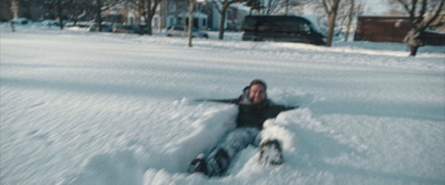 a person laying in the snow on their back