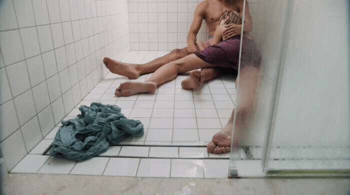 a man and a woman sitting in a shower