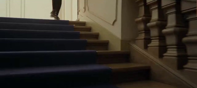 a woman is walking up a set of stairs