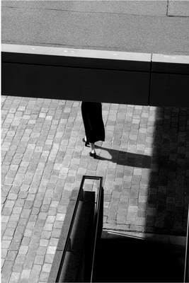 a black and white photo of a person with a suitcase