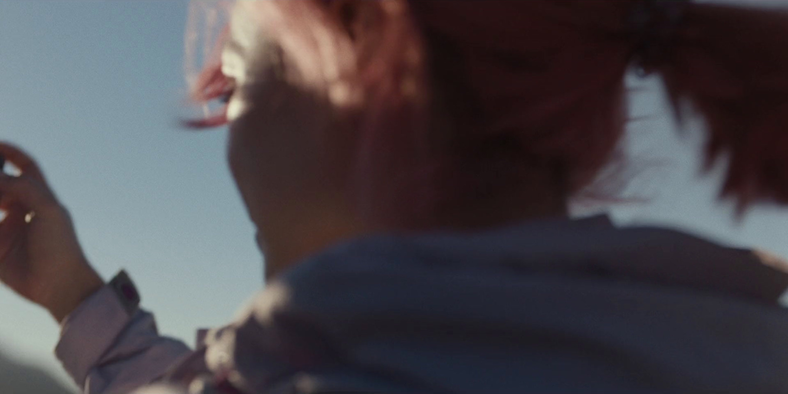 a woman is flying a kite in the sky