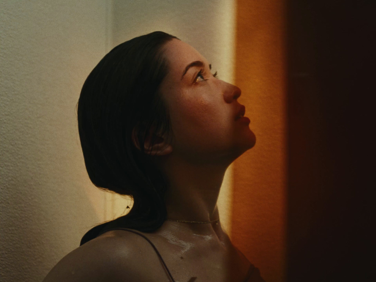 a woman standing in front of a wall looking up