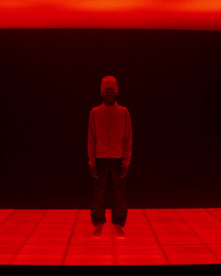 a man standing in front of a red background