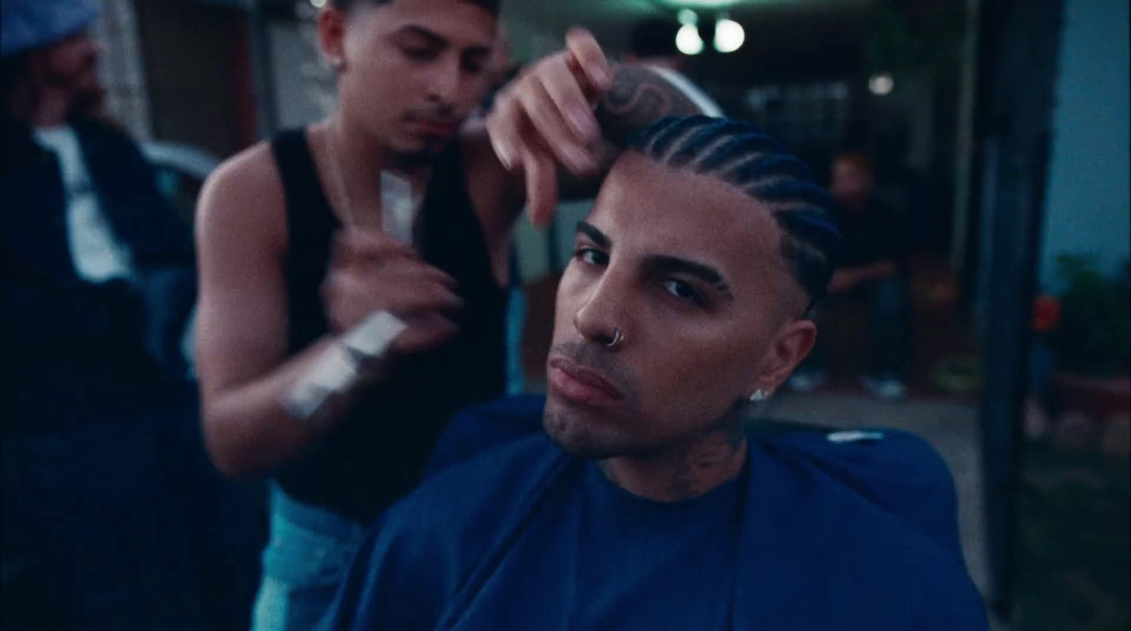 a man getting his hair cut by a woman