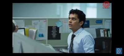 a man sitting at a desk in an office