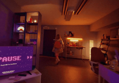 a woman standing in a room next to a tv