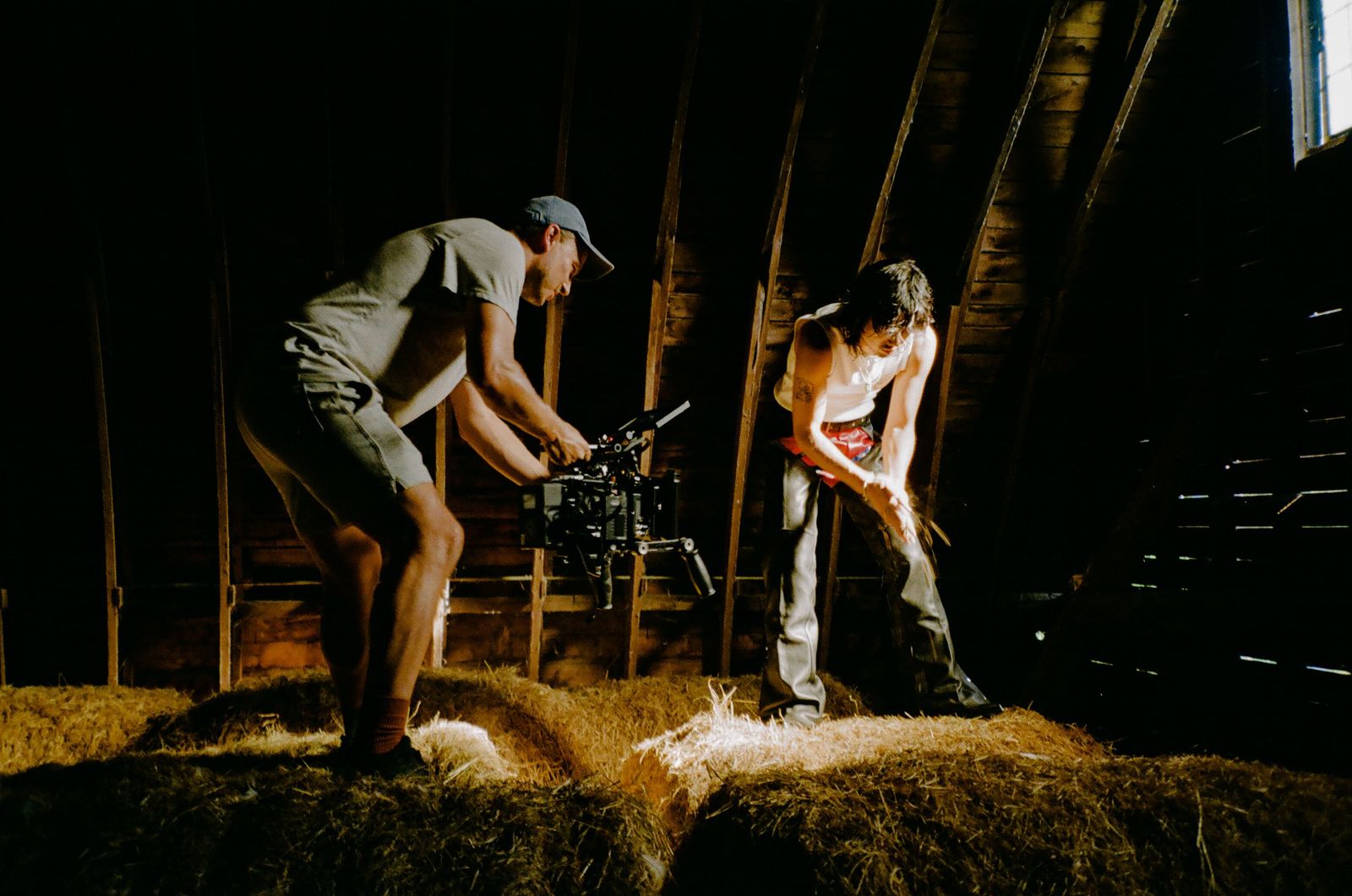 a couple of people that are standing in a barn