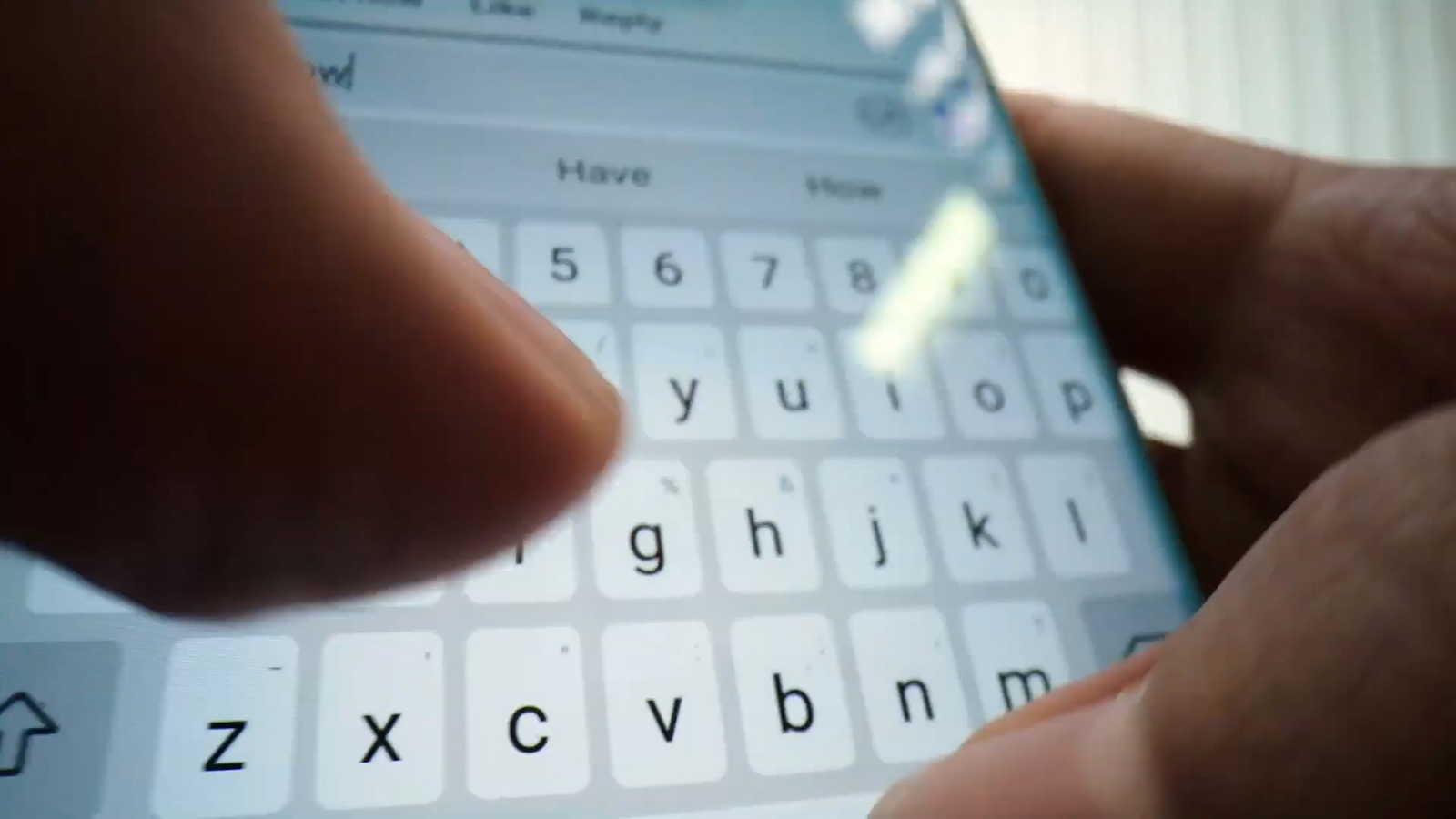 a close up of a person typing on a cell phone