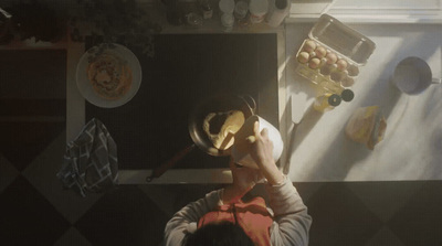 a person standing in a kitchen with a pan on his head