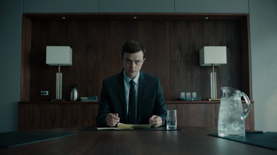 a man in a suit sitting at a table