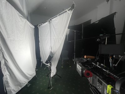 a photo studio with a white curtain and lights