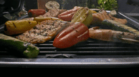 a bunch of food is cooking on a grill