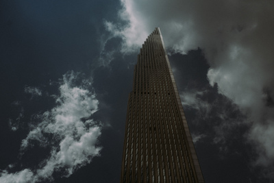 an image of a tall building under a cloudy sky